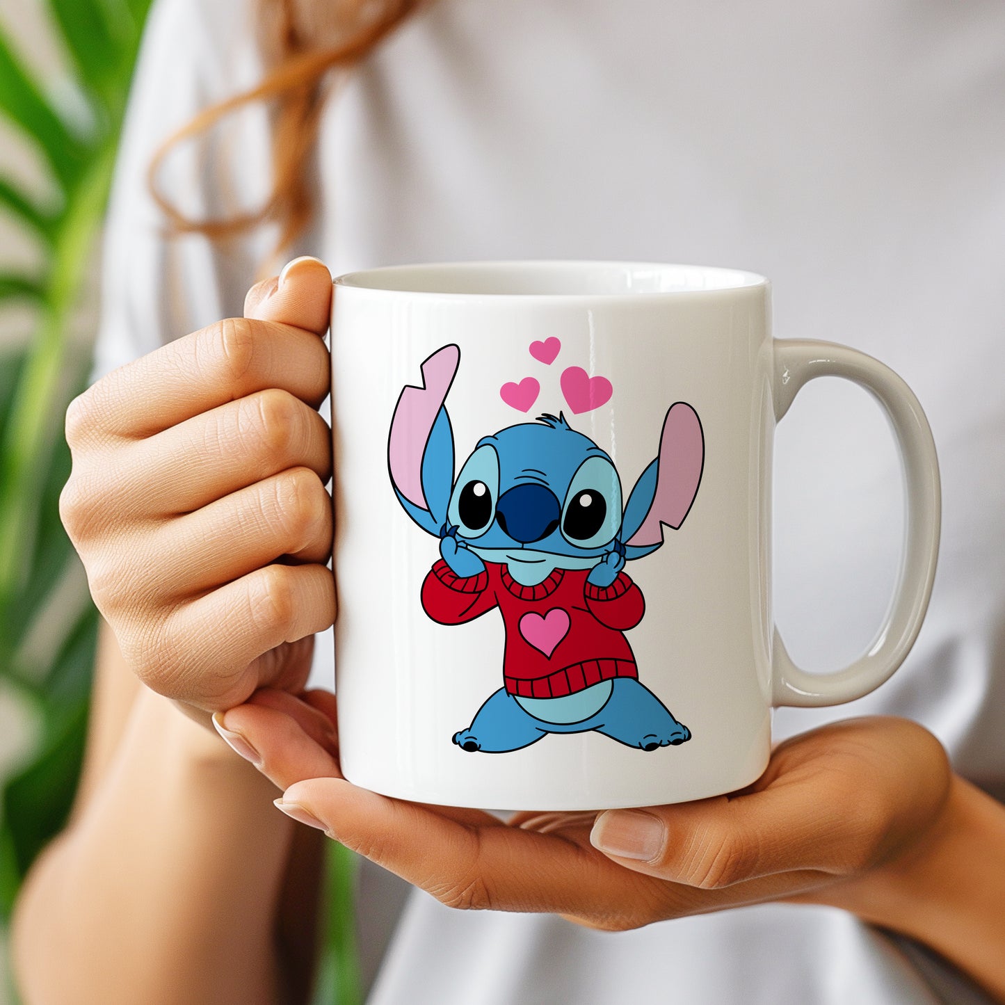 A white mug with a Valentine's Day Stitch design wearing a red sweater with hearts, perfect for DIY personalized gifts.